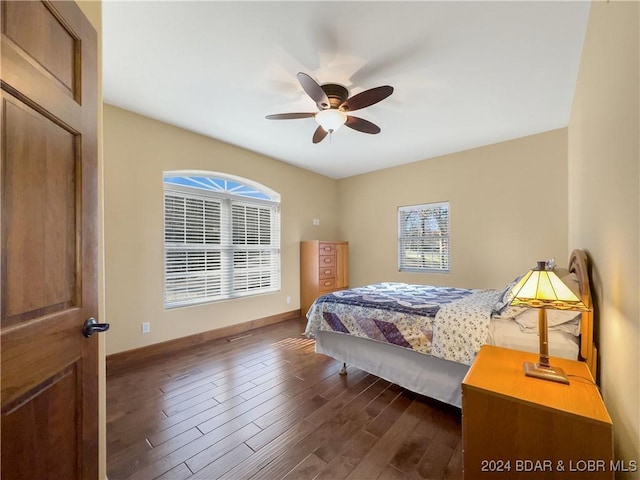 bedroom with dark hardwood / wood-style floors and ceiling fan