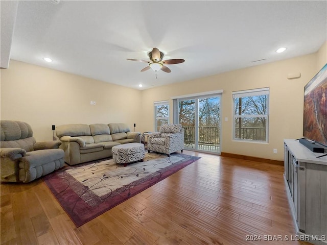 living room with ceiling fan and hardwood / wood-style flooring