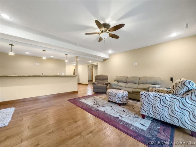 living room featuring ceiling fan and light hardwood / wood-style flooring