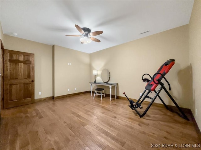 workout area featuring hardwood / wood-style flooring and ceiling fan