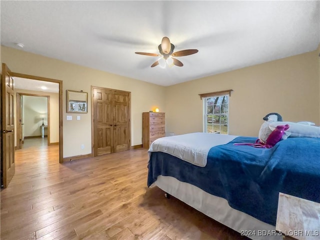 bedroom featuring light wood-type flooring and ceiling fan