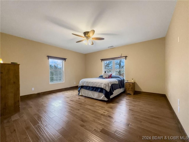 bedroom featuring ceiling fan and dark hardwood / wood-style floors