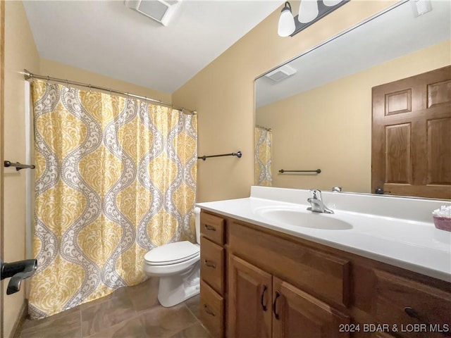 bathroom featuring tile patterned floors, vanity, and toilet