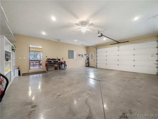 garage featuring ceiling fan, a garage door opener, and electric panel