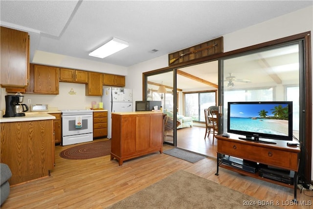 kitchen with ceiling fan, light wood-type flooring, white appliances, and a textured ceiling