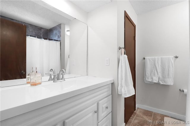 bathroom featuring tile patterned flooring, a shower with curtain, and vanity