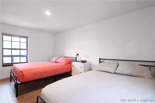 bedroom with hardwood / wood-style floors