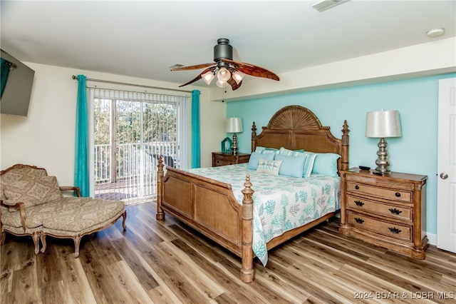 bedroom with ceiling fan, dark hardwood / wood-style floors, and access to outside