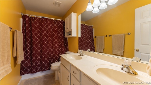 bathroom featuring tile patterned floors, vanity, toilet, and walk in shower