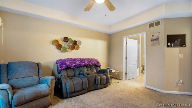 carpeted living room featuring ceiling fan