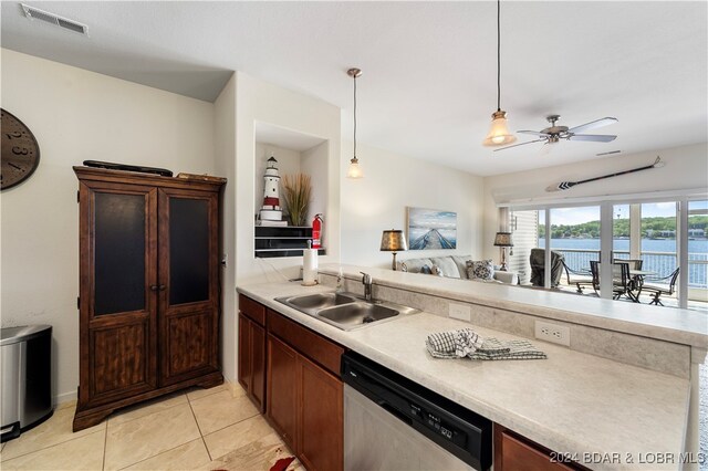 kitchen featuring dishwasher, sink, hanging light fixtures, a water view, and ceiling fan