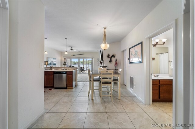 dining space featuring sink, light tile patterned floors, and ceiling fan