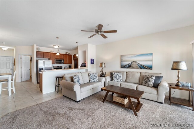 tiled living room featuring ceiling fan