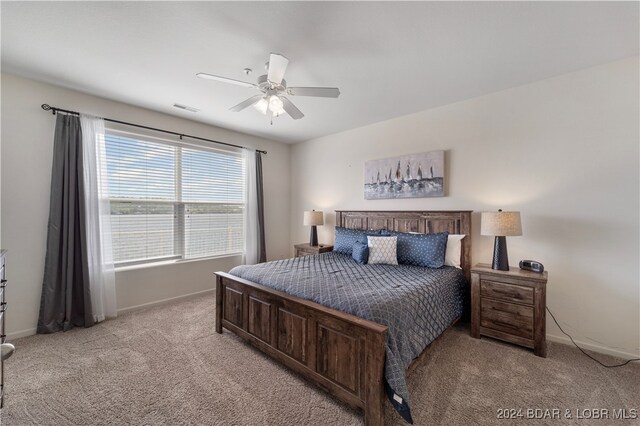 bedroom with light carpet and ceiling fan