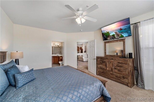 carpeted bedroom with ceiling fan and ensuite bathroom