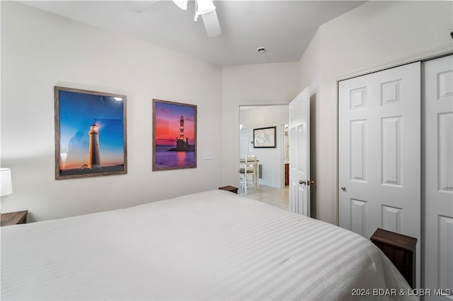 bedroom with ceiling fan and a closet