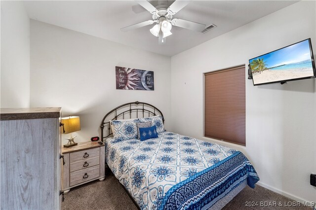 bedroom with dark colored carpet and ceiling fan