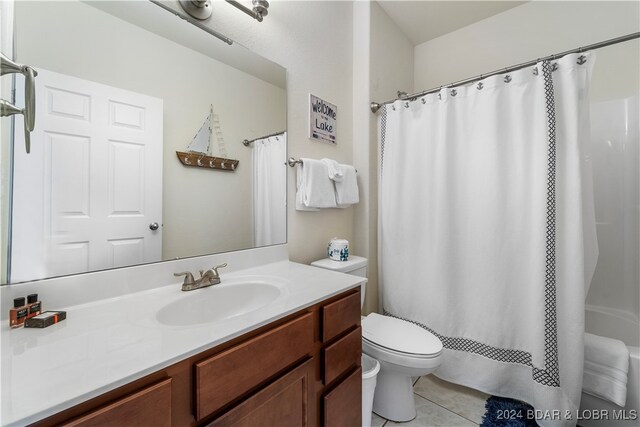 full bathroom with vanity, tile patterned flooring, toilet, and shower / tub combo