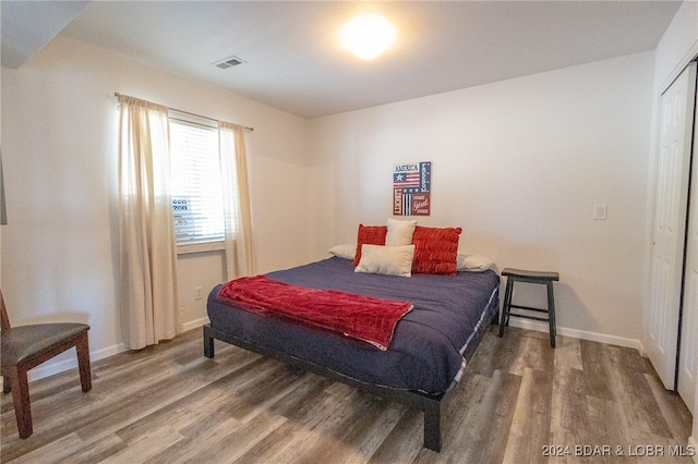 bedroom featuring hardwood / wood-style flooring and a closet