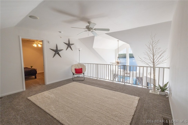 interior space with a water view, dark carpet, ceiling fan, and lofted ceiling