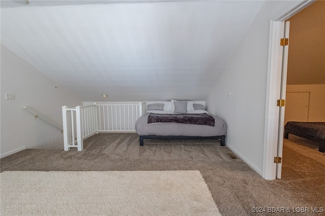 bedroom with carpet floors and vaulted ceiling