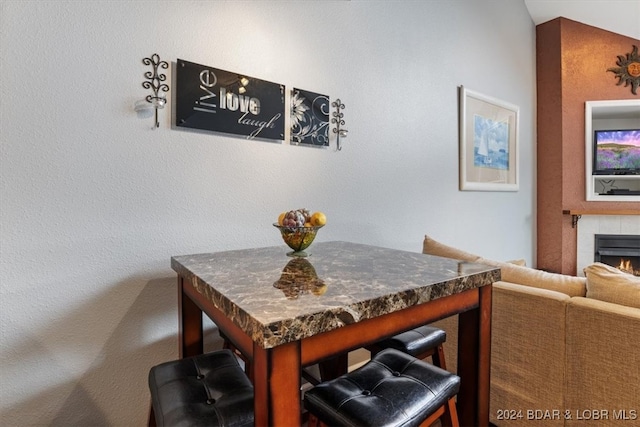 dining area featuring a tile fireplace