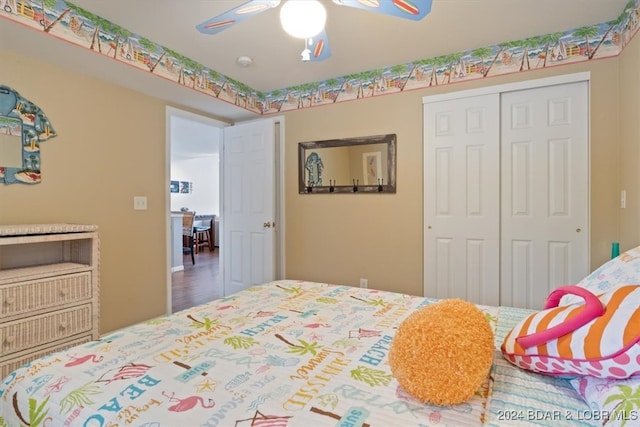 bedroom featuring ceiling fan, a closet, and hardwood / wood-style floors