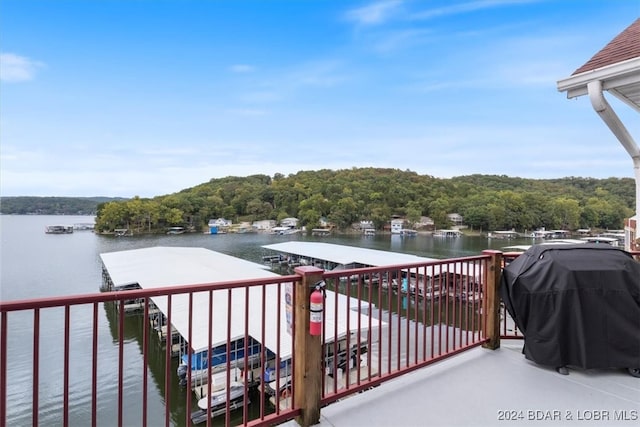 balcony with grilling area and a water view