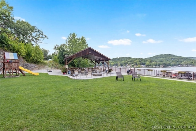 view of yard with a playground, a gazebo, and a water and mountain view