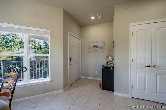 foyer entrance with light tile patterned floors