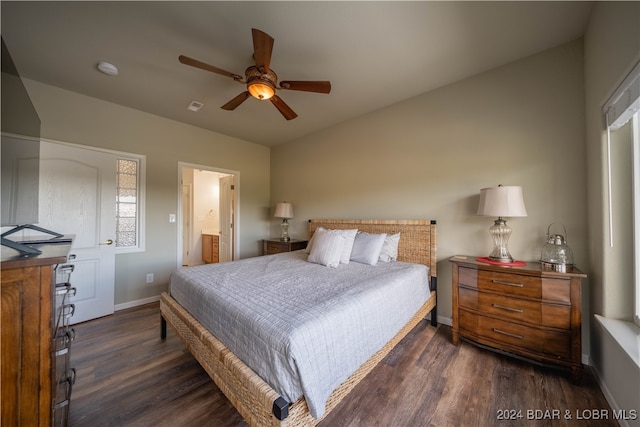 bedroom with ensuite bath, ceiling fan, and dark hardwood / wood-style flooring