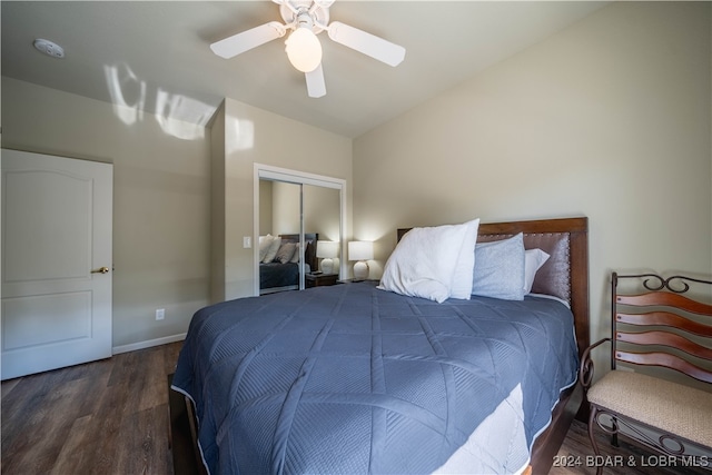 bedroom featuring lofted ceiling, a closet, dark hardwood / wood-style floors, and ceiling fan