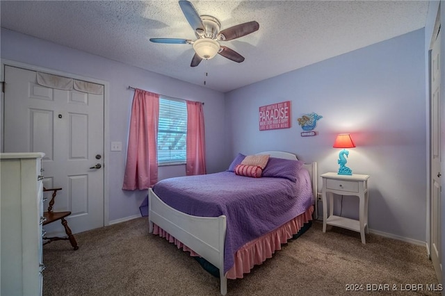 bedroom with carpet flooring, ceiling fan, a closet, and a textured ceiling