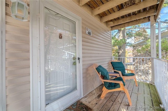 exterior space with beam ceiling and wooden ceiling