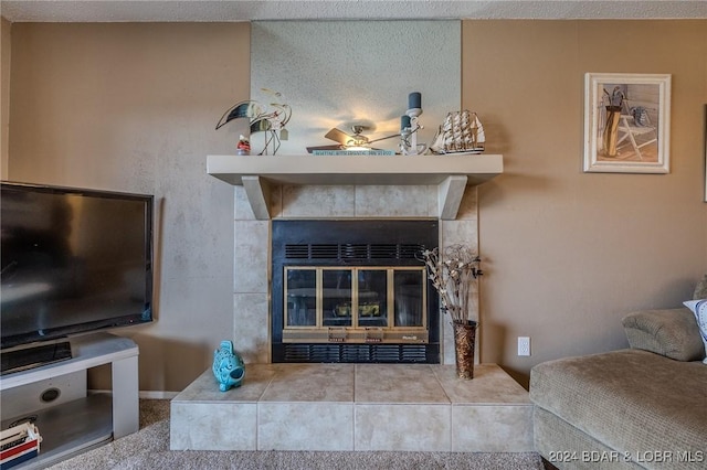 living room with a tiled fireplace