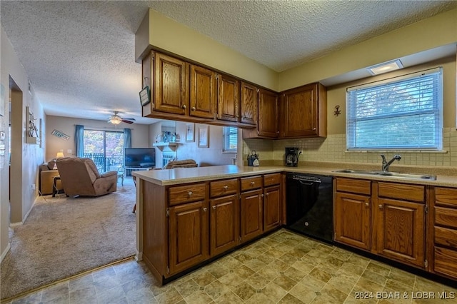 kitchen featuring sink, ceiling fan, black dishwasher, light colored carpet, and kitchen peninsula