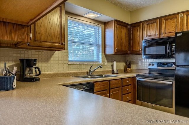 kitchen with backsplash, sink, and black appliances