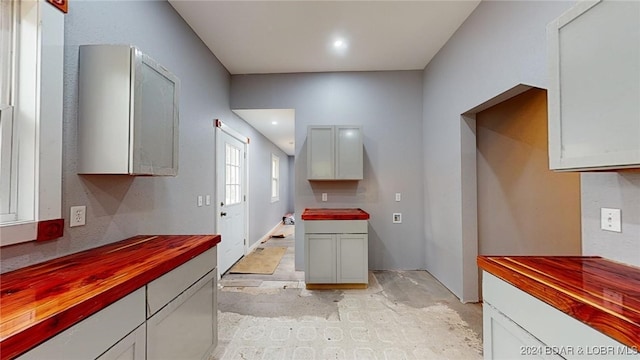 kitchen with white cabinetry and butcher block counters