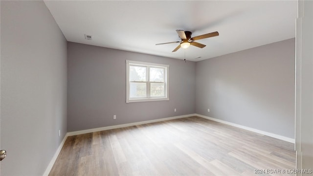 empty room with ceiling fan and light wood-type flooring