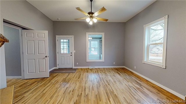 foyer entrance with ceiling fan and light wood-type flooring