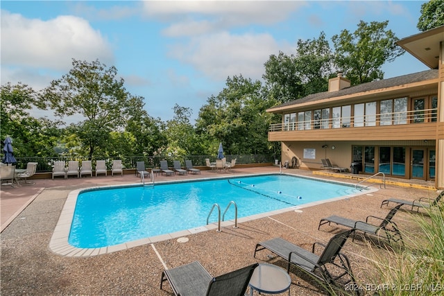 view of swimming pool with a patio