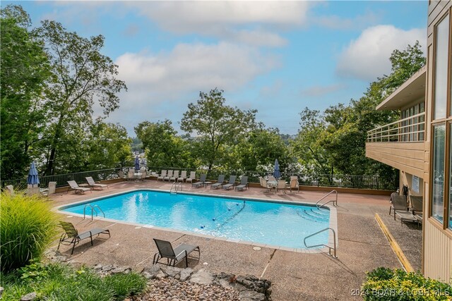 view of swimming pool with a patio area