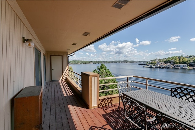 wooden terrace featuring a water view