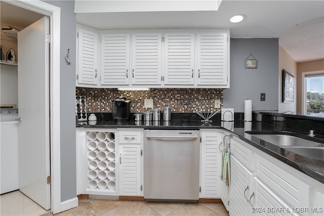 kitchen featuring white cabinets, tasteful backsplash, stainless steel dishwasher, and dark stone counters