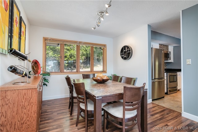 dining room featuring hardwood / wood-style floors and a textured ceiling