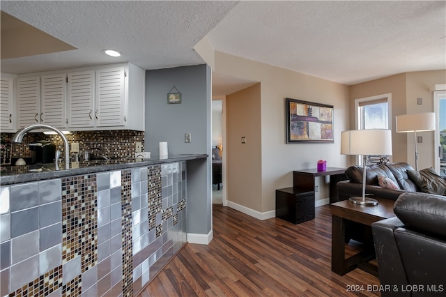 interior space featuring a textured ceiling and dark hardwood / wood-style floors