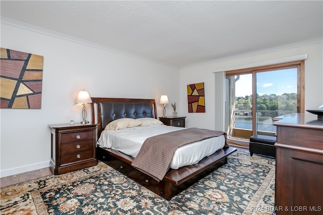 bedroom with crown molding, a water view, and light wood-type flooring