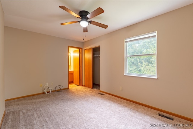 unfurnished bedroom with ceiling fan, a closet, and light colored carpet