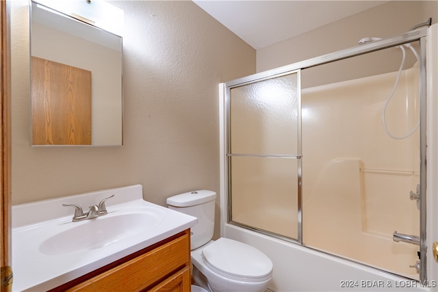 full bathroom featuring toilet, vanity, and combined bath / shower with glass door