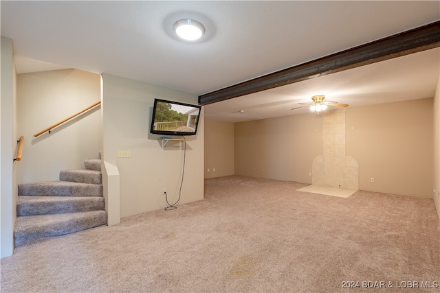 living room featuring ceiling fan, beamed ceiling, and carpet